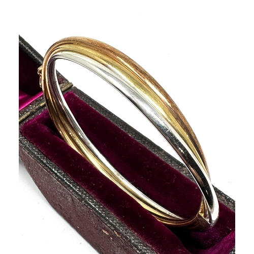 141 - 9ct gold three coloured gold bangle weight 8.9g