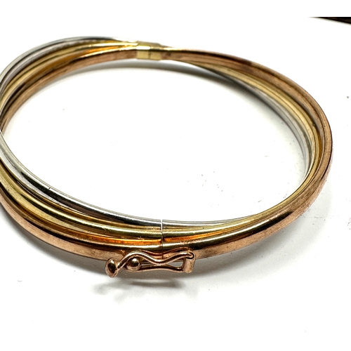 141 - 9ct gold three coloured gold bangle weight 8.9g