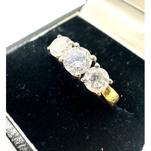 142 - 18ct gold diamond ring set with three diamonds the centre diamond measures approx 5mm with diamonds ... 