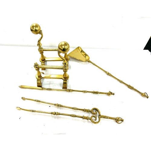 201 - Pair of brass fire dogs and a selection of brass companion set items shovel, etc