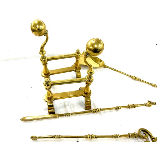 201 - Pair of brass fire dogs and a selection of brass companion set items shovel, etc