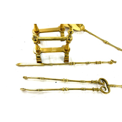 201 - Pair of brass fire dogs and a selection of brass companion set items shovel, etc