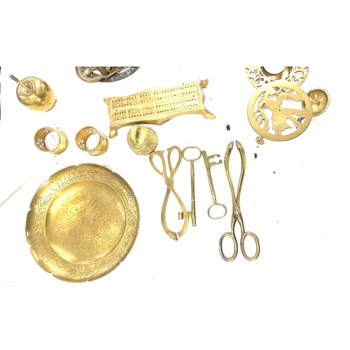 179 - Large selection of brass items to include napkin rings, salt shaker, candle holders etc