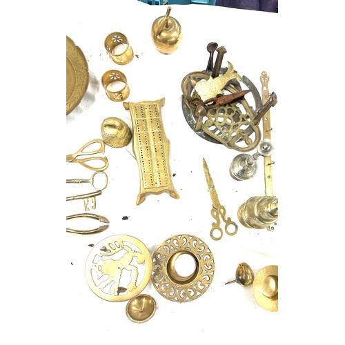 179 - Large selection of brass items to include napkin rings, salt shaker, candle holders etc