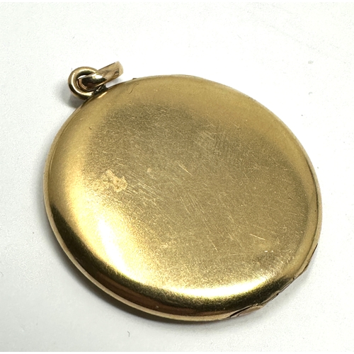 124 - Antique gold shell & enamel locket measures approx  3.2cm dia