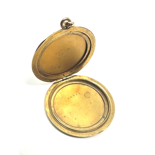 124 - Antique gold shell & enamel locket measures approx  3.2cm dia