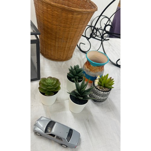 251 - Selection of home ware items to include faux plants, wicker basket, plant stand etc