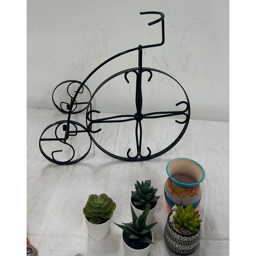 251 - Selection of home ware items to include faux plants, wicker basket, plant stand etc