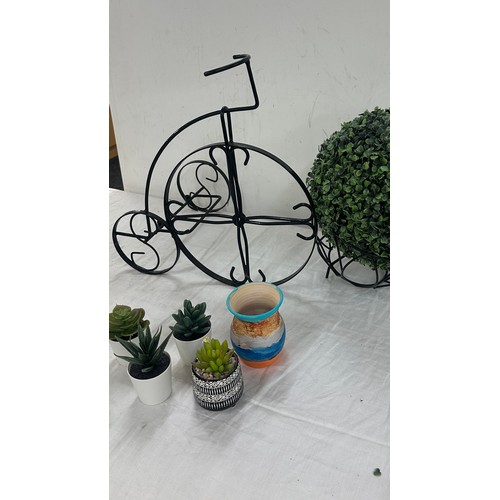 251 - Selection of home ware items to include faux plants, wicker basket, plant stand etc