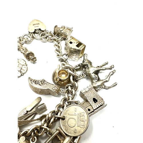 247 - Vintage silver charm bracelet and charms inc opening charms weight 78g