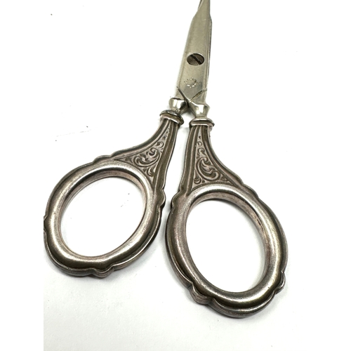 31 - Antique silver handle sewing scissors measure approx 9.5cm long in good condition