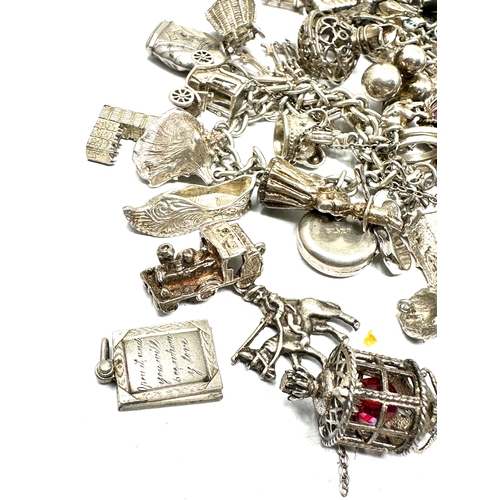 260 - Large selection of vintage silver charm bracelets and loose charms weight 228g