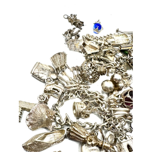 260 - Large selection of vintage silver charm bracelets and loose charms weight 228g