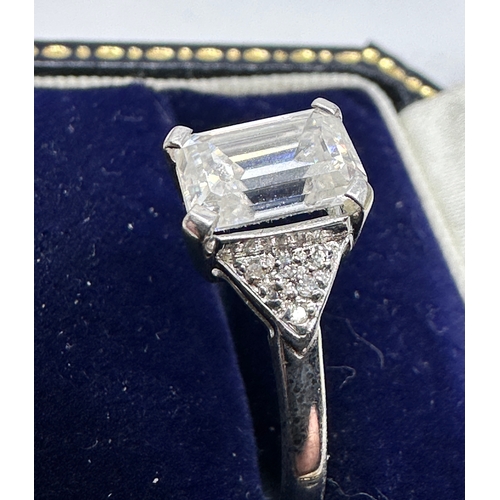 152 - 18ct white gold emerald cut diamond ring diamond measures approx 7.5mm by 5.5cm est 1.5ct with diamo... 