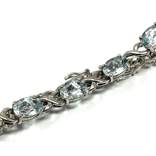 123 - 9ct white gold blue gemstone tennis bracelet weight  8.6 grams