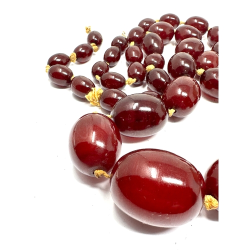 206 - large cherry amber / bakelite bead necklace largest central bead measures approx 31mm by 23mm total ... 