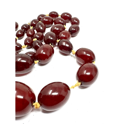 206 - large cherry amber / bakelite bead necklace largest central bead measures approx 31mm by 23mm total ... 