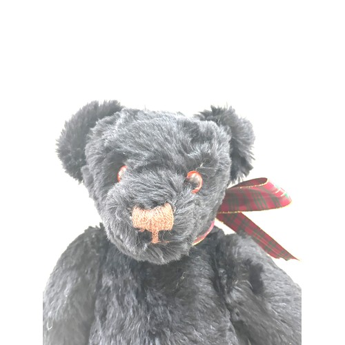 57 - Large black merrythought bear label to foot, approximately 50cm tall