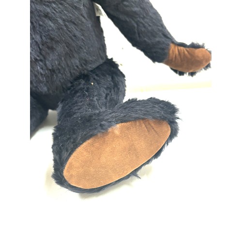 57 - Large black merrythought bear label to foot, approximately 50cm tall