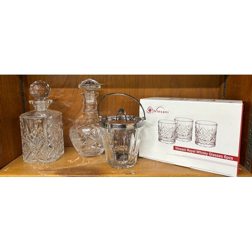 47 - Two cut glass decanters an ice bucket with filter and serving tongs and a set of 6 spirit glasses un... 