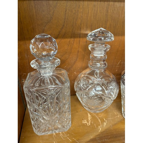 47 - Two cut glass decanters an ice bucket with filter and serving tongs and a set of 6 spirit glasses un... 