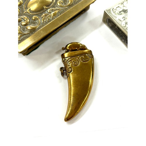 519 - Novelty 20th century brass vesta case in the shape of a boar tusk with a boar to the lid, brass matc... 