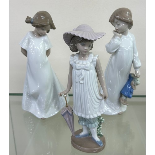 511 - Three NAO by Lladro figurines to include ' April Showers', ' My Rag Doll', etc