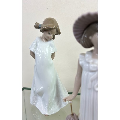 511 - Three NAO by Lladro figurines to include ' April Showers', ' My Rag Doll', etc