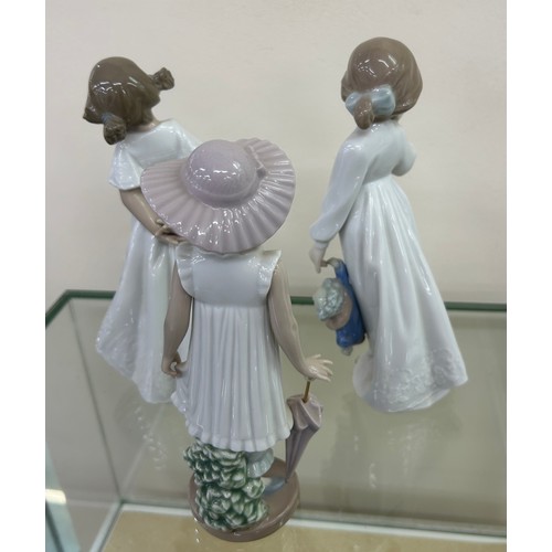 511 - Three NAO by Lladro figurines to include ' April Showers', ' My Rag Doll', etc