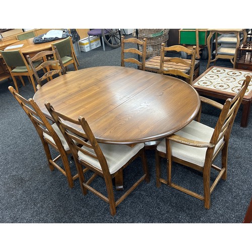 346 - Golden oak Ercol extendable oval table with four chairs and two carvers - measures approximately whe... 