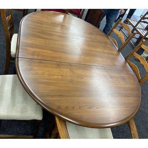 346 - Golden oak Ercol extendable oval table with four chairs and two carvers - measures approximately whe... 