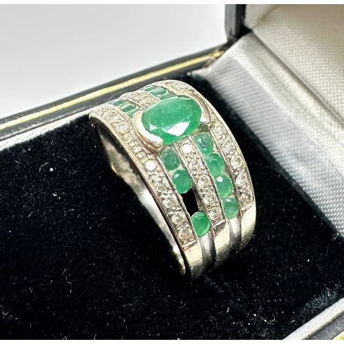 183 - 9ct white gold diamond & emerald ring weight 4.3g missing small emerald