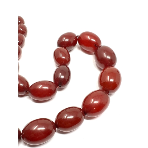 86 - Fine antique cherry amber bakelite bead necklace good internal streaking largest bead measures appro... 