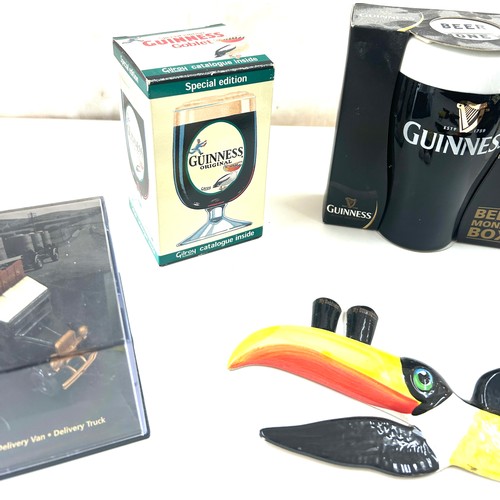 587 - Selection of Guinness memorabilia includes Money Box, marmite jar, Wall hanging toucans etc