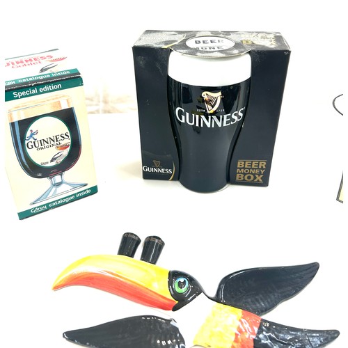 587 - Selection of Guinness memorabilia includes Money Box, marmite jar, Wall hanging toucans etc