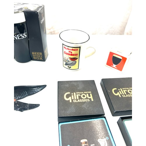 587 - Selection of Guinness memorabilia includes Money Box, marmite jar, Wall hanging toucans etc