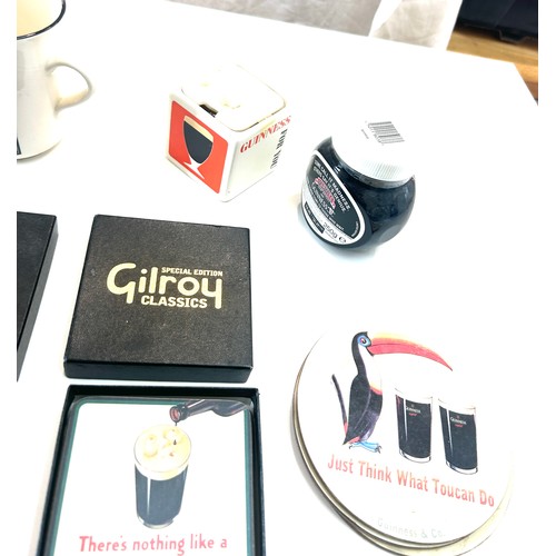 587 - Selection of Guinness memorabilia includes Money Box, marmite jar, Wall hanging toucans etc