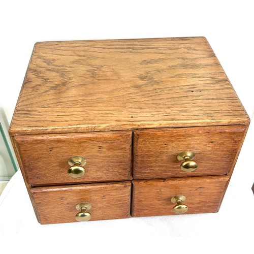 53 - Small oak 4 drawer chest measures approximately 10 inches tall 13 inches wide 9 inches depth