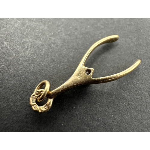 159 - Vintage 9ct gold wishbone charm weight .8 g