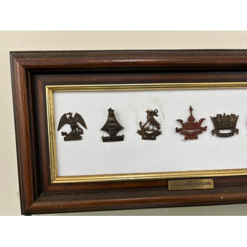 95 - Selection of 7 Royal Navy Division cap badges in frame