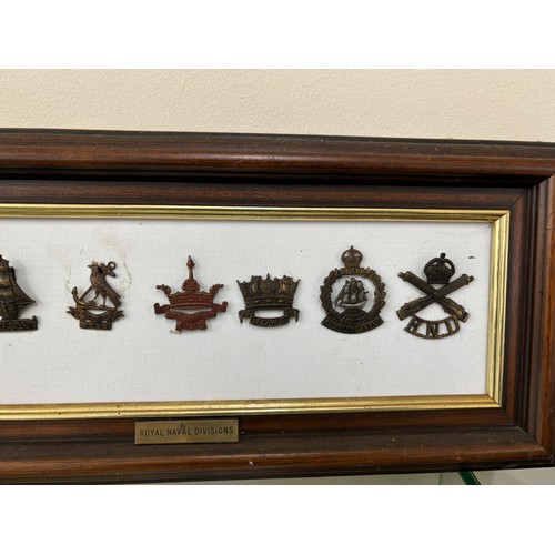 95 - Selection of 7 Royal Navy Division cap badges in frame