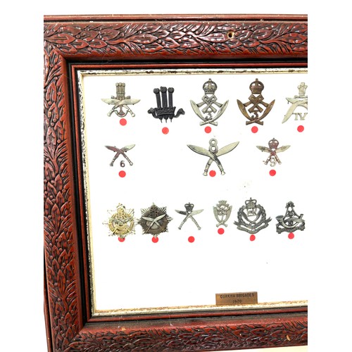 46 - Framed Gurkha cap badges