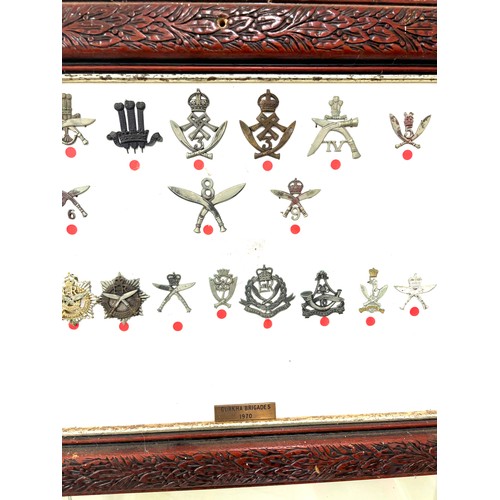 46 - Framed Gurkha cap badges