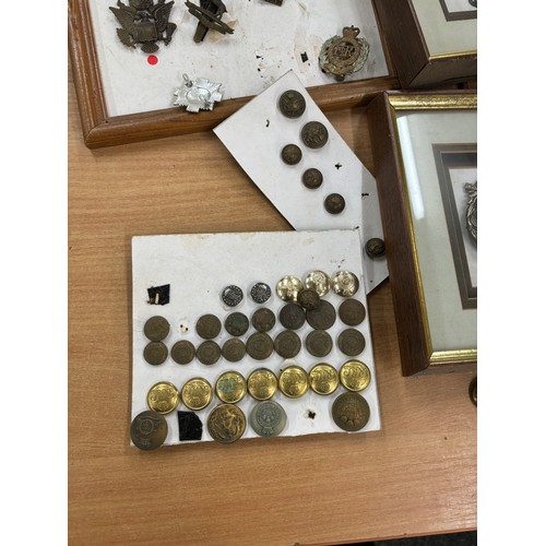 108 - Selection of assorted framed cap cadges, buttons and a signature