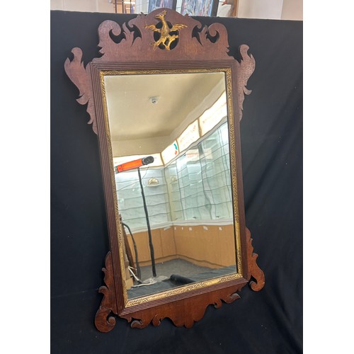 87 - Oak framed mirror measures approximately 20 inches tall x 16 wide