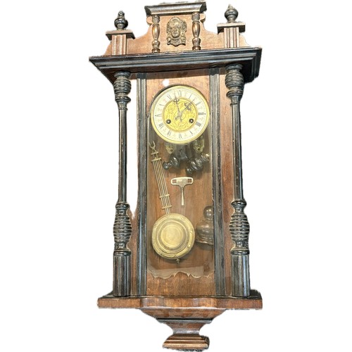 67 - Mahogany 2 keyhole wall clock, with key and pendulum, pverall height 34 inches