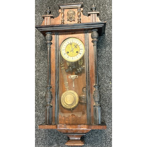 67 - Mahogany 2 keyhole wall clock, with key and pendulum, pverall height 34 inches