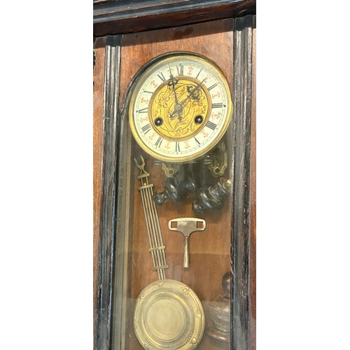 67 - Mahogany 2 keyhole wall clock, with key and pendulum, pverall height 34 inches