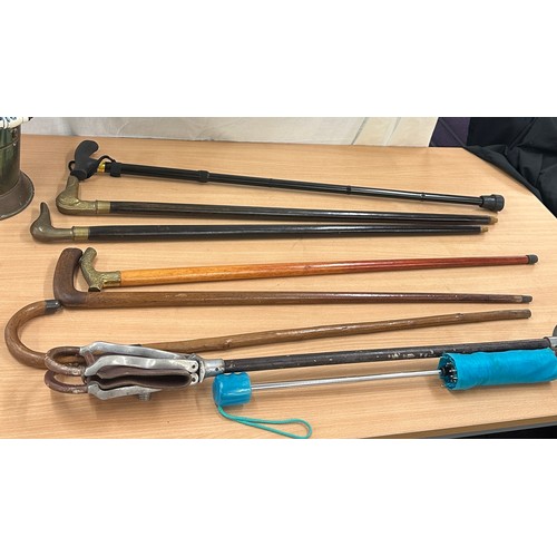 226 - Selection of assorted walking sticks, umbrellas, etc, with a walking stick holder etc