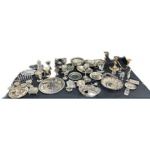 191 - Large selection of silver plated ware includes candle sticks, toast rack, egg cups etc